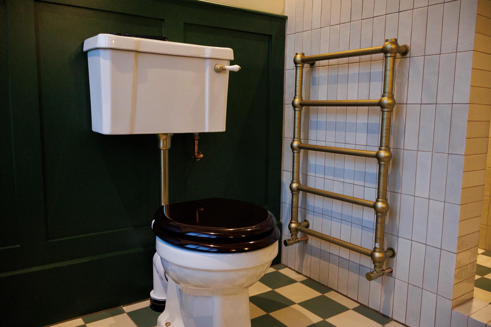 Traditional bathroom with brass fixtures and checkered floor