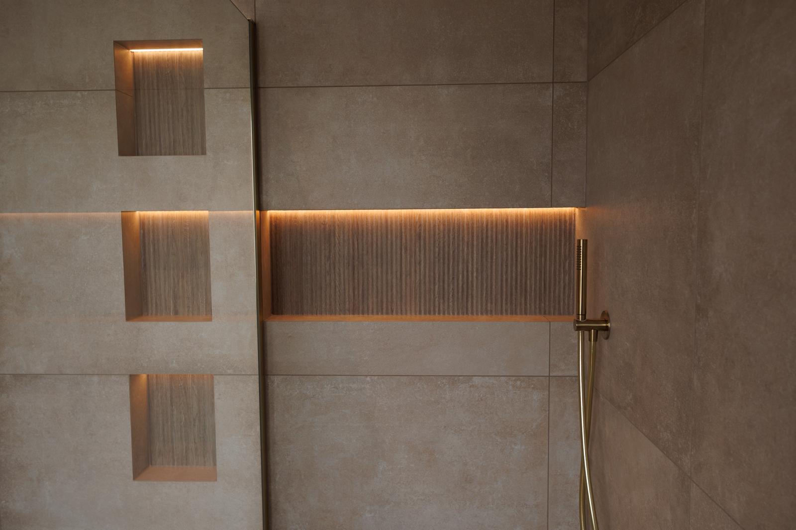 Modern shower with LED lighting and brass fixtures