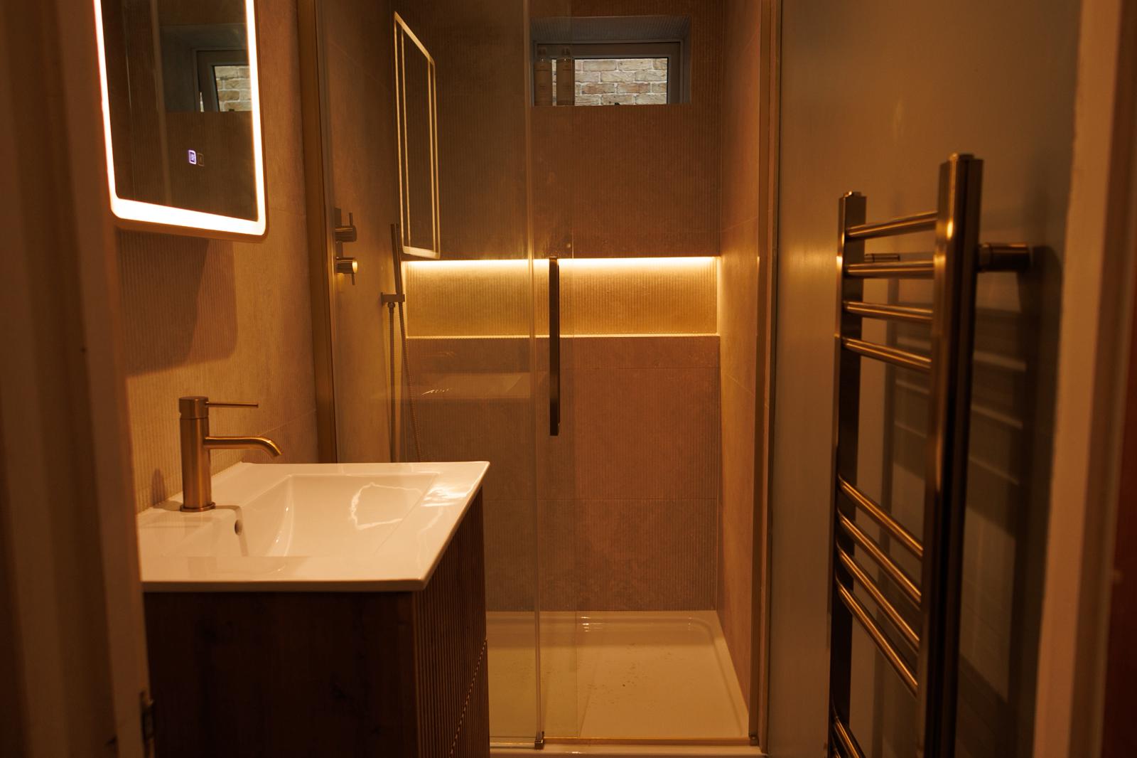 Complete bathroom with walk-in shower and modern lighting